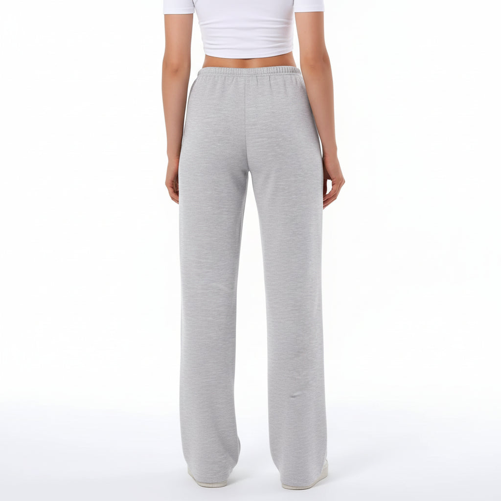 Gray sweatpants worn by a person on a white background