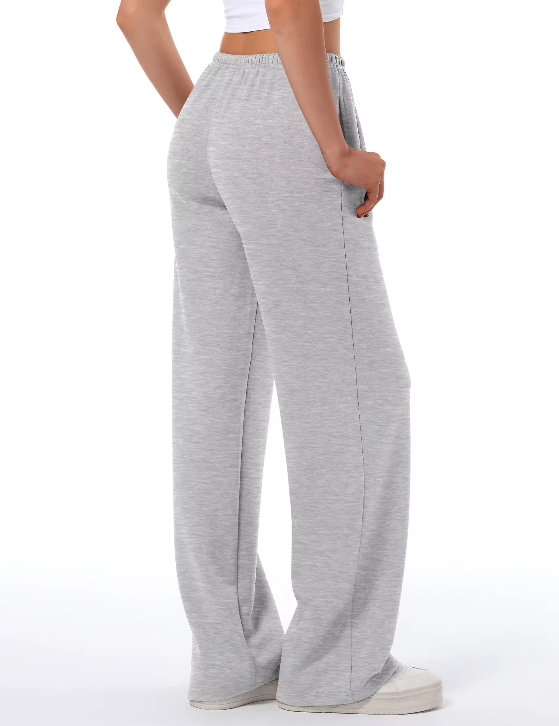 Gray sweatpants worn by a person on a white background